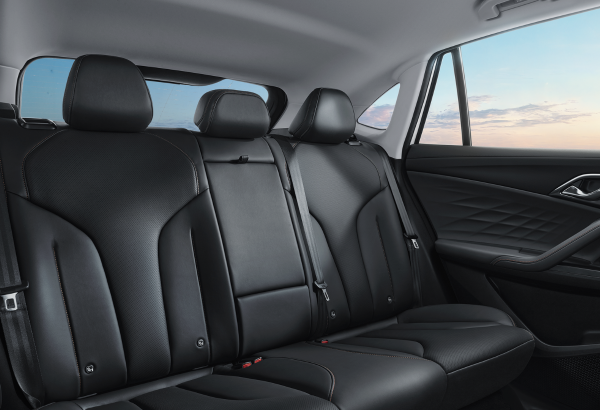 Black leather rear seats of a MG HS Hybrid Pluswith seat belts and stitching.